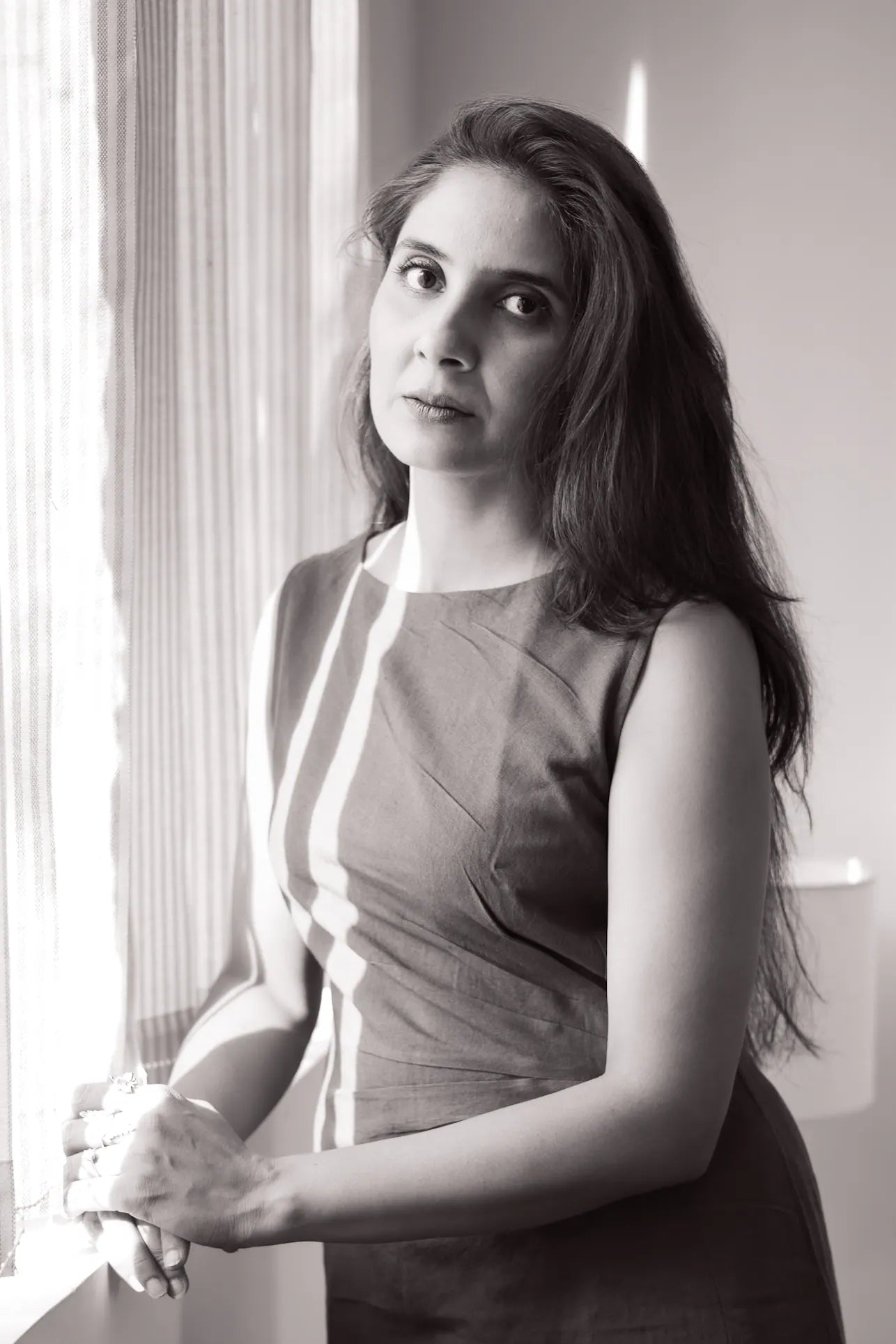 Priyanka by a window, black and white